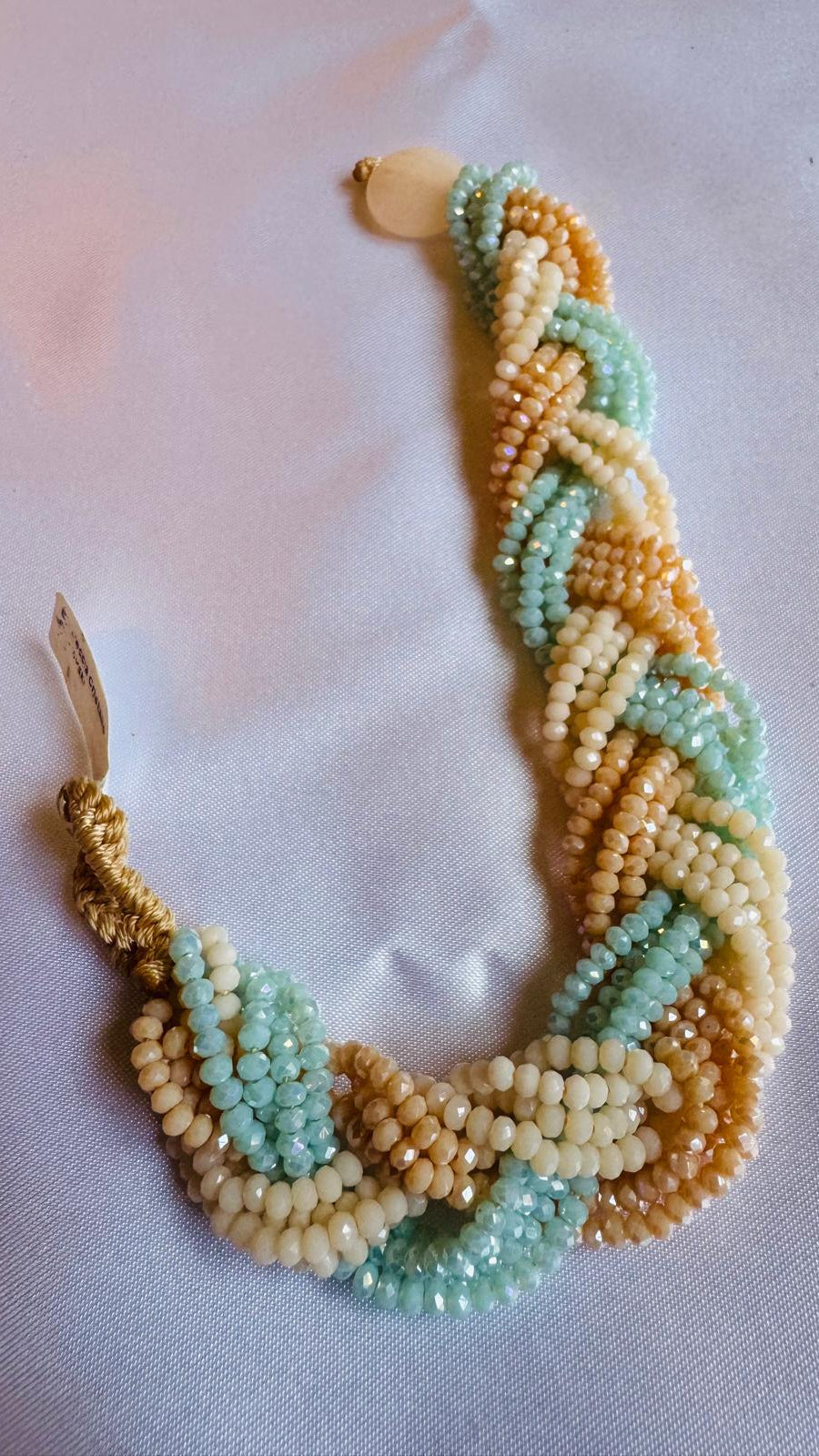 Braided beaded bracelet with green, beige colors